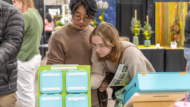 two people leaning over educational game